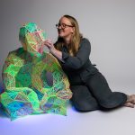 Marian Sandberg, Small Language Model, 2025<br />
3D printed noctilucent plastic on nylon jersey, bricklayers twine, UV light.<br />
1.5m x 1.2m x 1.2m<br />
Photo: James Field