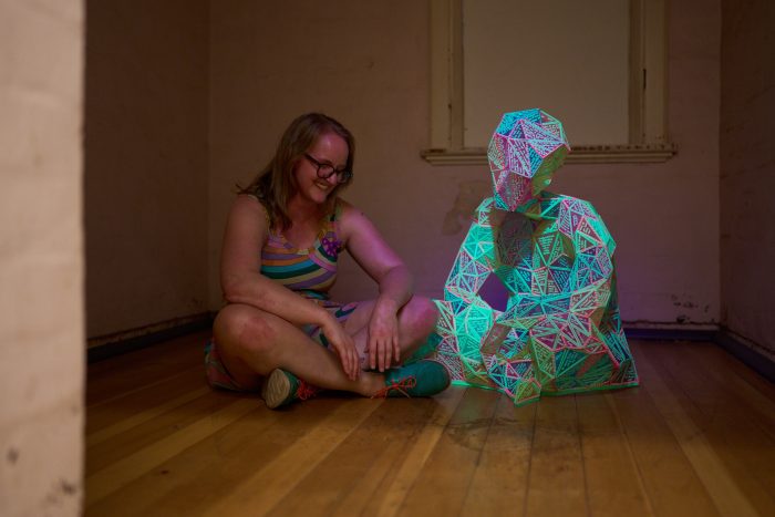 Marian Sandberg, Small Language Model, 2025<br />
3D printed noctilucent plastic on nylon jersey, bricklayers twine, UV light.<br />
1.5m x 1.2m x 1.2m<br />
Photo: Sam Roberts