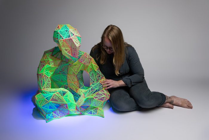 Marian Sandberg, Small Language Model, 2025<br />
3D printed noctilucent plastic on nylon jersey, bricklayers twine, UV light.<br />
1.5m x 1.2m x 1.2m<br />
Photo: James Field